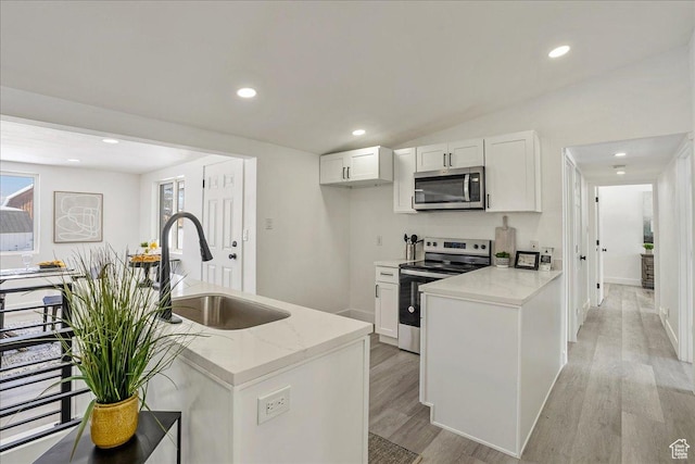 7046 S 2955 E, Cottonwood Heights, UT 84121 - kitchen with stainless steel appliances, light wood-style floors, white cabinets, and a sink