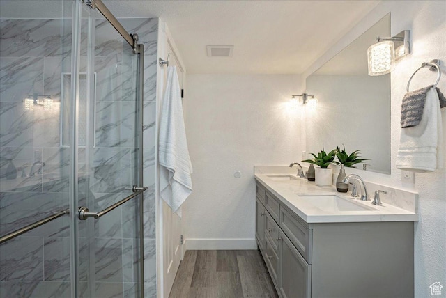7046 S 2955 E, Cottonwood Heights, UT 84121 - bathroom featuring a stall shower, wood finished floors, double vanity, and a sink