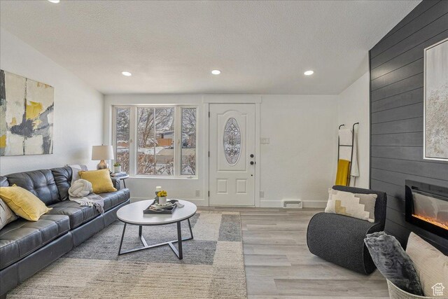 7046 S 2955 E, Cottonwood Heights, UT 84121 - living area featuring recessed lighting, light wood finished floors, a fireplace, and a textured ceiling