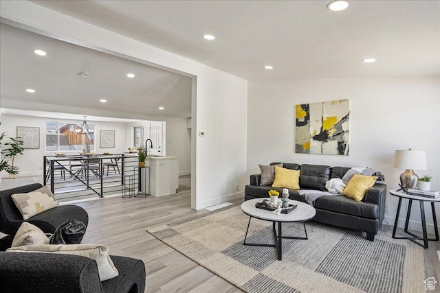 7046 S 2955 E, Cottonwood Heights, UT 84121 - living area featuring an inviting chandelier, a textured ceiling, recessed lighting, light wood finished floors, and baseboards