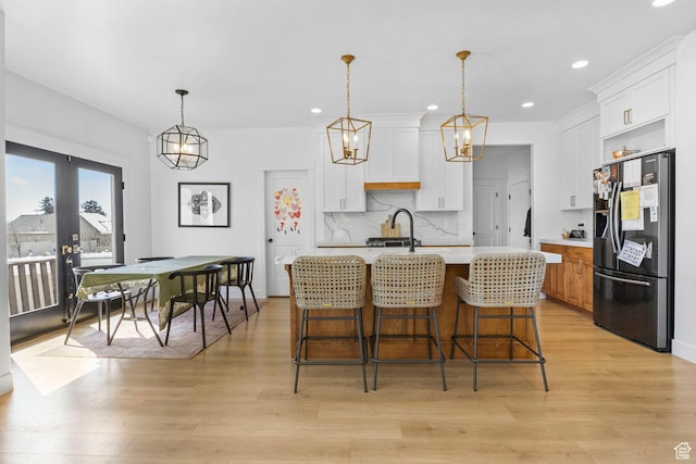 764 E 760 S, Pleasant Grove, UT 84062 - kitchen with light wood-type flooring, stainless steel fridge, tasteful backsplash, and light countertops