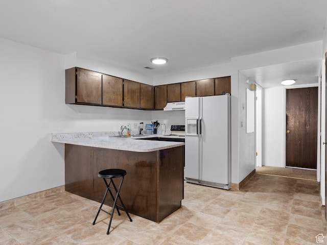1162 E 400 S, Salt Lake City, UT 84102 - kitchen featuring light countertops, a peninsula, white fridge with ice dispenser, dark brown cabinetry, and under cabinet range hood