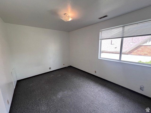 1162 E 400 S, Salt Lake City, UT 84102 - empty room featuring baseboards, visible vents, and dark colored carpet