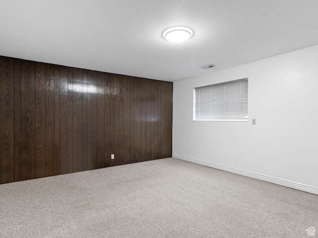 1162 E 400 S, Salt Lake City, UT 84102 - carpeted empty room featuring visible vents, wooden walls, and a textured ceiling