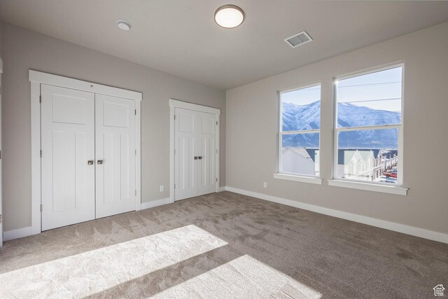 2744 E 1060 S, Spanish Fork, UT 84660 - unfurnished bedroom with visible vents, multiple closets, baseboards, and carpet flooring