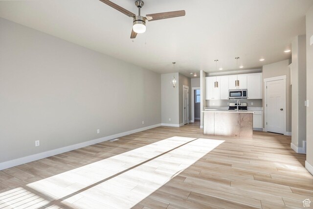 2744 E 1060 S, Spanish Fork, UT 84660 - unfurnished living room with light wood finished floors, recessed lighting, baseboards, and ceiling fan