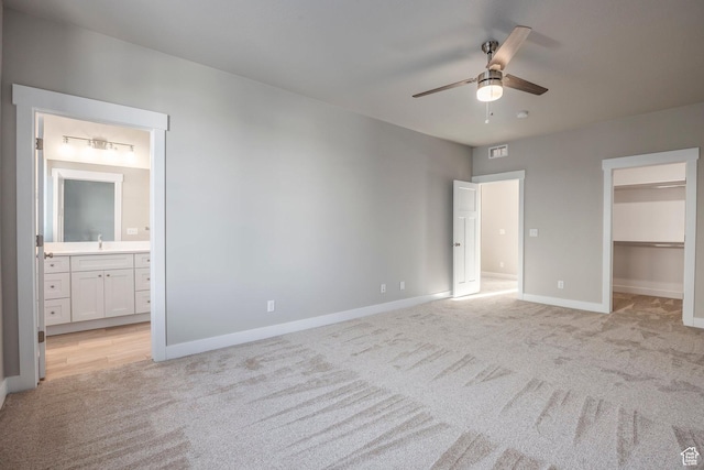 2744 E 1060 S, Spanish Fork, UT 84660 - unfurnished bedroom with a walk in closet, light colored carpet, visible vents, and a sink