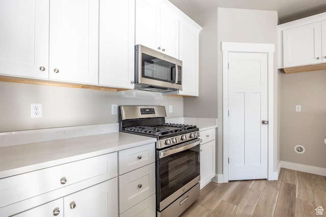 2744 E 1060 S, Spanish Fork, UT 84660 - kitchen featuring white cabinetry, stainless steel appliances, light countertops, and light wood-style floors