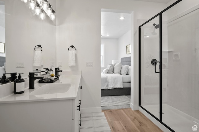 336 W Rosie Loop Unit 45W, Cedar City, UT 84721 - ensuite bathroom featuring wood finished floors, a stall shower, double vanity, and baseboards