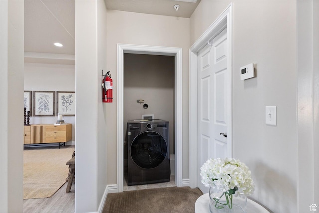 laundry area featuring washer / clothes dryer, baseboards, carpet, and wood finished floors
