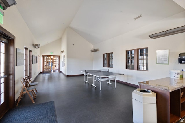 rec room with french doors, baseboards, and high vaulted ceiling