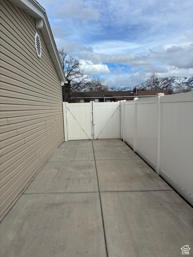 view of patio with fence and a gate