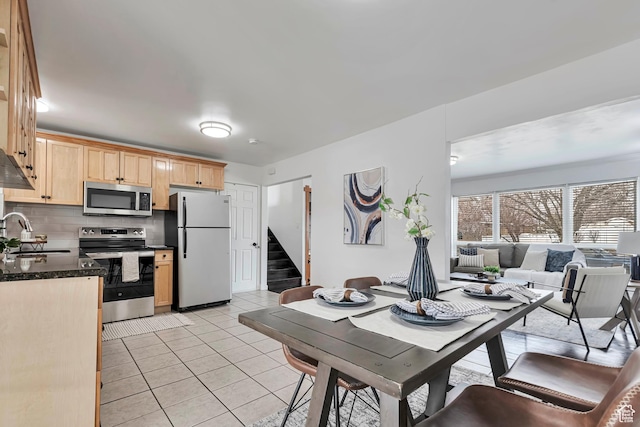 dining room featuring stairway and light tile patterned floors
