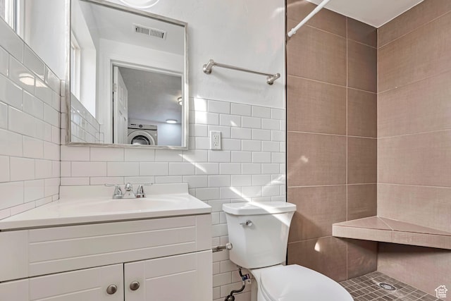 full bath featuring visible vents, decorative backsplash, vanity, toilet, and tile walls