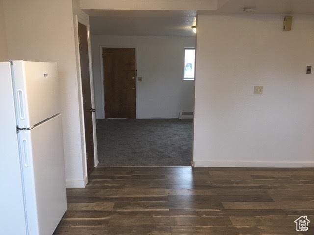301 W 500 N, Logan, UT 84321 - kitchen with freestanding refrigerator, a baseboard heating unit, and wood finished floors