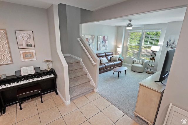 4532 W Cave Run Ln S, South Jordan, UT 84009 - living room with light colored carpet, a ceiling fan, baseboards, stairway, and light tile patterned floors