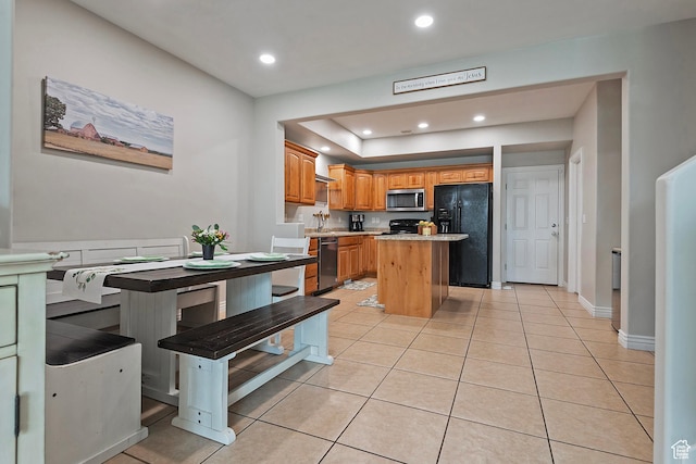 4532 W Cave Run Ln S, South Jordan, UT 84009 - kitchen with black appliances, a center island, recessed lighting, light tile patterned floors, and light countertops