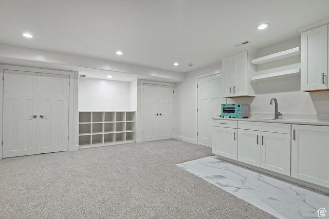 4532 W Cave Run Ln S, South Jordan, UT 84009 - kitchen with a sink, open shelves, recessed lighting, white cabinets, and light carpet