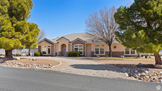 846 S 800 E, New Harmony, UT 84757 - view of front facade with stone siding, stucco siding, a tile roof, and fence
