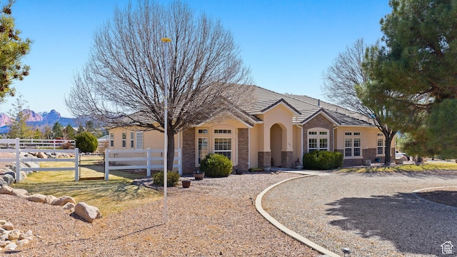846 S 800 E, New Harmony, UT 84757 - view of front of property with stone siding, stucco siding, a tile roof, and fence