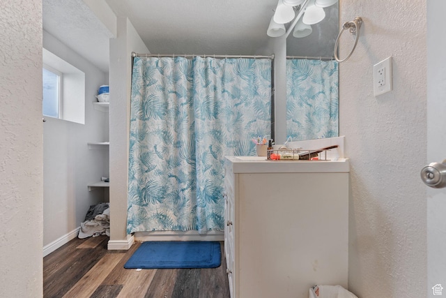 5623 Brandy Wine St, Taylorsville, UT 84118 - bathroom featuring vanity, a shower with shower curtain, baseboards, and wood finished floors