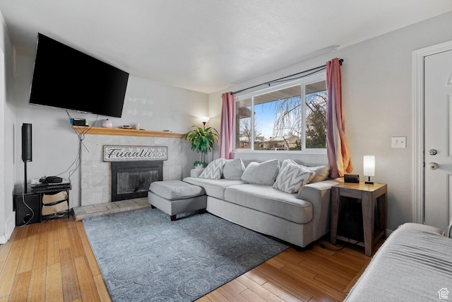 5623 Brandy Wine St, Taylorsville, UT 84118 - living room featuring hardwood / wood-style floors and a glass covered fireplace