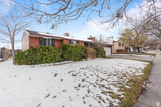 5623 Brandy Wine St, Taylorsville, UT 84118 - ranch-style home featuring brick siding, an attached garage, and driveway