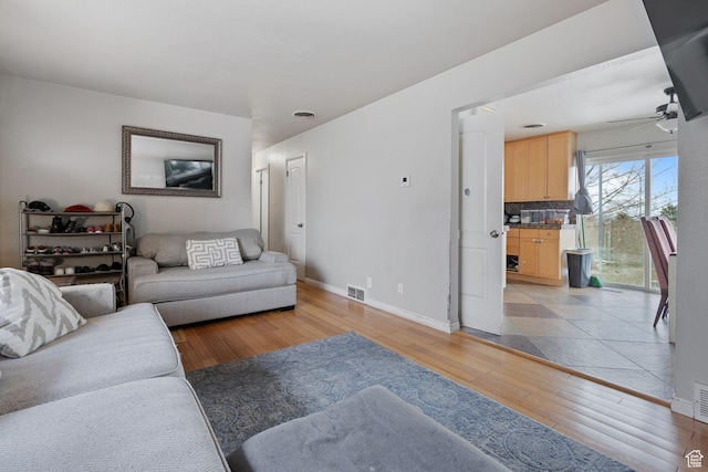 5623 Brandy Wine St, Taylorsville, UT 84118 - living area with visible vents, baseboards, light wood-style floors, and ceiling fan