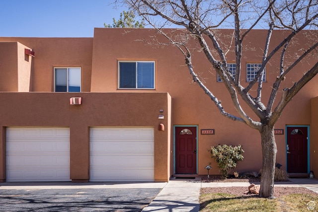 view of front of house featuring stucco siding and an attached garage