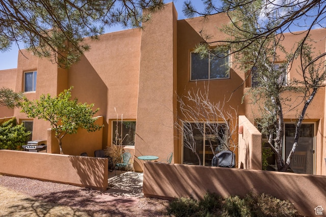 3354 E Fairway Loop, Moab, UT 84532 - back of house with stucco siding and a patio