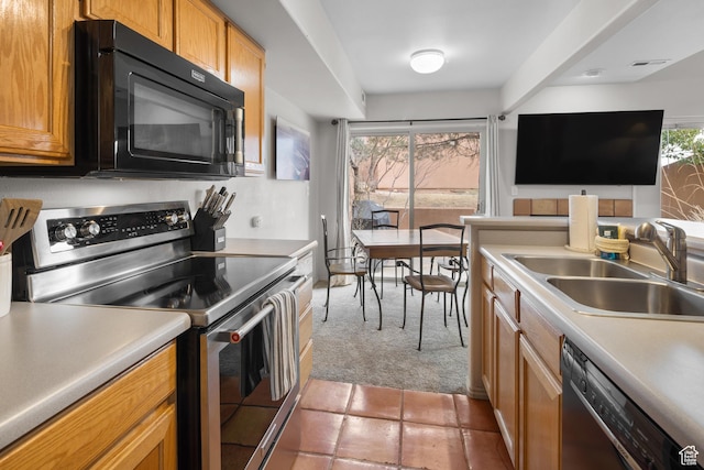 3354 E Fairway Loop, Moab, UT 84532 - kitchen with light countertops, a sink, light carpet, and appliances with stainless steel finishes