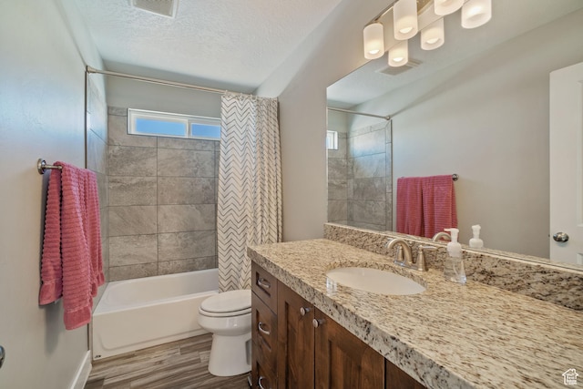 2558 Mountain Glen Rd, Erda, UT 84074 - full bathroom featuring toilet, wood finished floors, shower / bath combo, vanity, and a textured ceiling