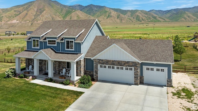 2558 Mountain Glen Rd, Erda, UT 84074 - view of front of property featuring board and batten siding, a garage, stone siding, and concrete driveway