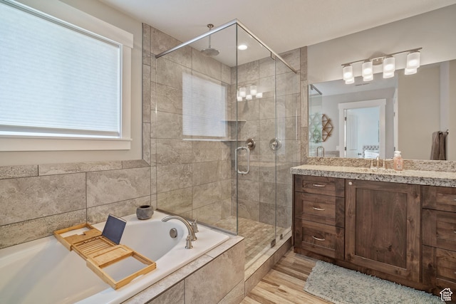 2558 Mountain Glen Rd, Erda, UT 84074 - bathroom with a shower stall, vanity, a bath, and wood finished floors