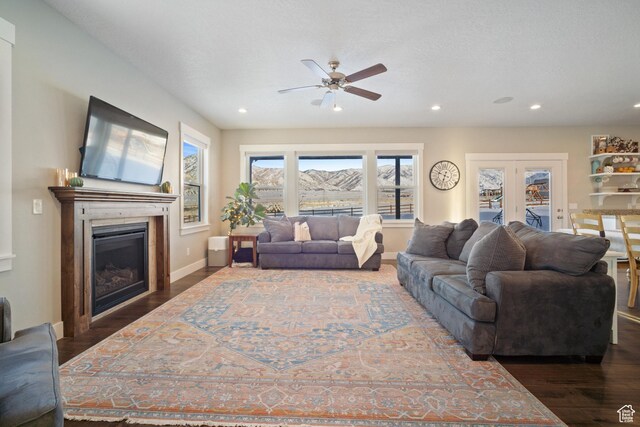 2558 Mountain Glen Rd, Erda, UT 84074 - living room with ceiling fan, a glass covered fireplace, wood finished floors, recessed lighting, and baseboards
