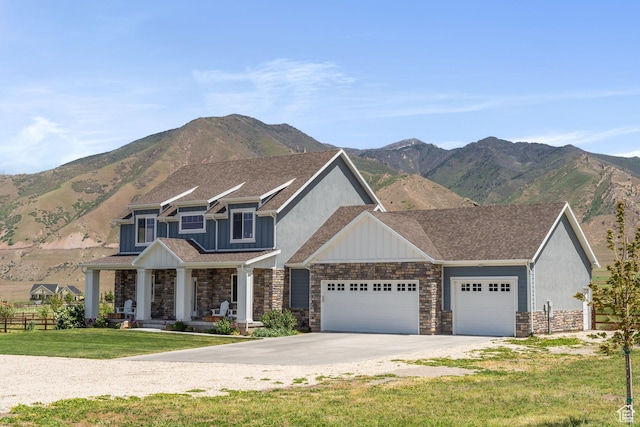 2558 Mountain Glen Rd, Erda, UT 84074 - craftsman inspired home with an attached garage, stone siding, a porch, concrete driveway, and a mountain view