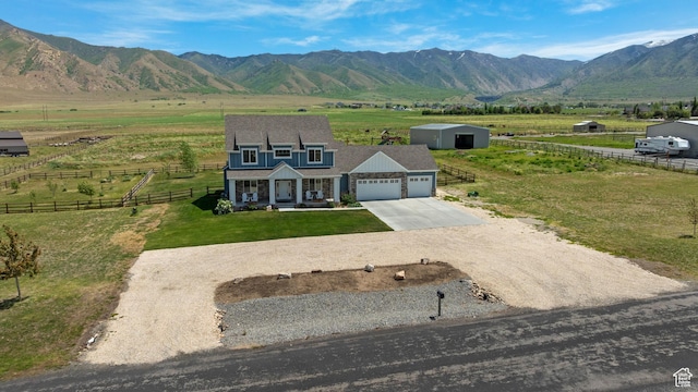 2558 Mountain Glen Rd, Erda, UT 84074 - shingle-style home featuring an attached garage, driveway, a view of rural / pastoral area, and covered porch