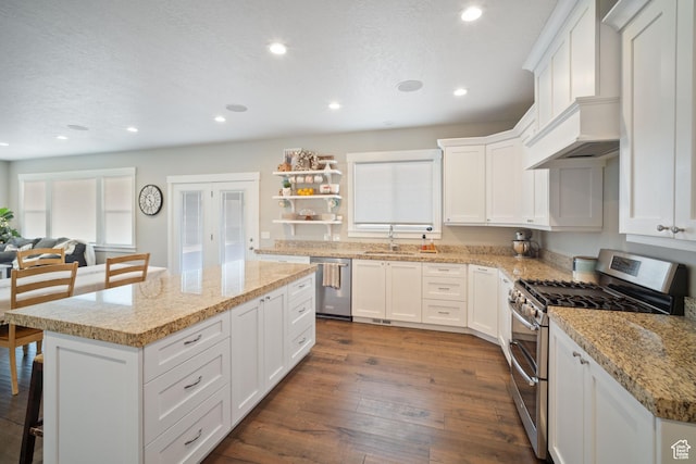 2558 Mountain Glen Rd, Erda, UT 84074 - kitchen with stainless steel appliances, a sink, a center island, recessed lighting, and custom exhaust hood