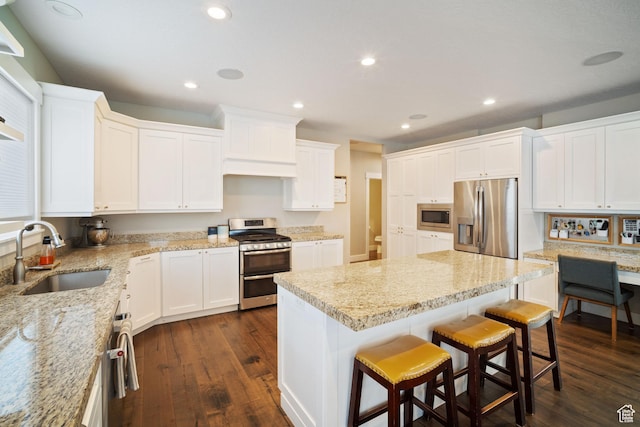 2558 Mountain Glen Rd, Erda, UT 84074 - kitchen featuring appliances with stainless steel finishes, a sink, dark wood-style floors, recessed lighting, and white cabinetry