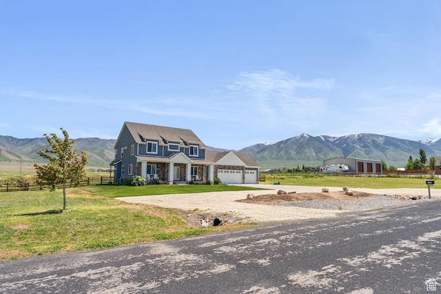 2558 Mountain Glen Rd, Erda, UT 84074 - view of front facade with a mountain view, a garage, driveway, a view of countryside, and stone siding
