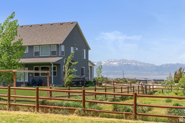 2558 Mountain Glen Rd, Erda, UT 84074 - back of property featuring a shingled roof, a mountain view, and a rural view