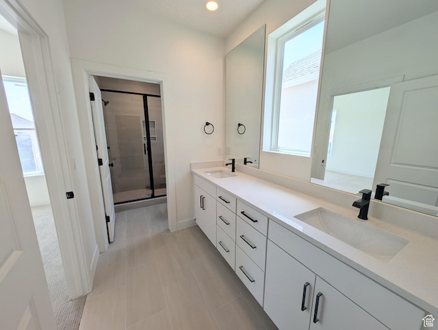 7077 W Granbury Dr S Unit 257, South Jordan, UT 84009 - bathroom with plenty of natural light, double vanity, a stall shower, recessed lighting, and tile patterned flooring