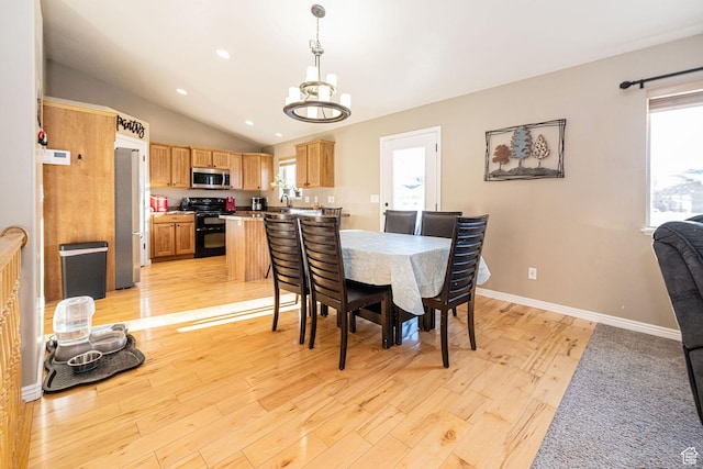 624 N 800 E, Wellsville, UT 84339 - dining room with a chandelier, lofted ceiling, healthy amount of natural light, light wood-style floors, and baseboards