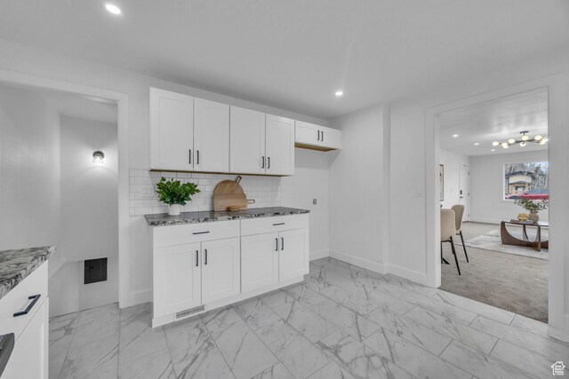 590 E 7th St, Ogden, UT 84404 - kitchen with marble finish floor, backsplash, recessed lighting, white cabinets, and stone counters