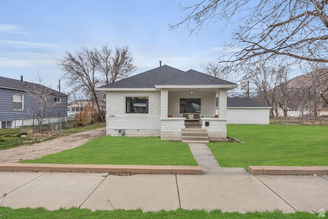 590 E 7th St, Ogden, UT 84404 - view of front of house featuring brick siding, a front lawn, a porch, roof with shingles, and crawl space