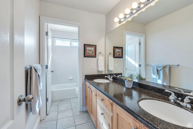 bathroom with tile patterned flooring, double vanity, a sink, and toilet