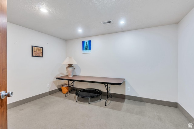 carpeted office space featuring recessed lighting, visible vents, baseboards, and a textured ceiling