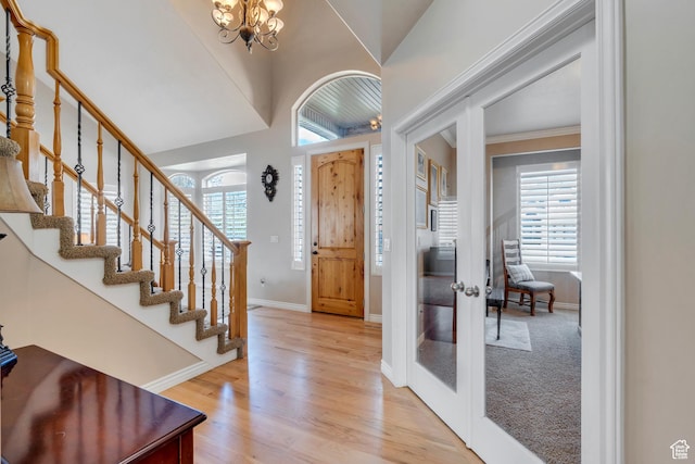 foyer entrance with french doors, a healthy amount of sunlight, and stairway