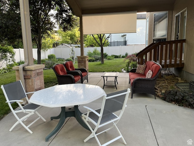 view of patio featuring outdoor dining area, outdoor lounge area, and a fenced backyard