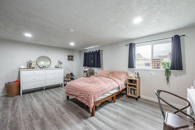 3061 W 13800 S, Bluffdale, UT 84065 - bedroom featuring recessed lighting, light wood-style flooring, a textured ceiling, and baseboards